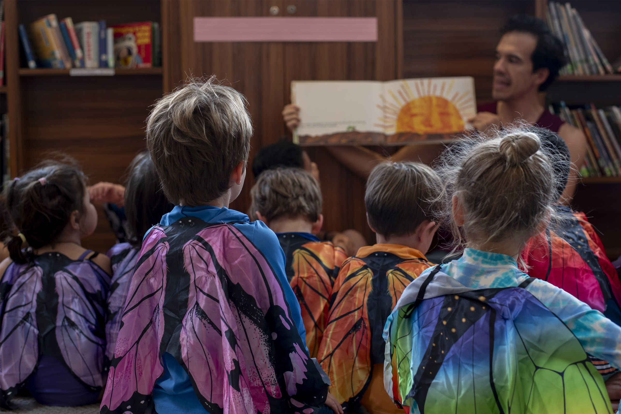Kids dressed as butterflies listening to a story